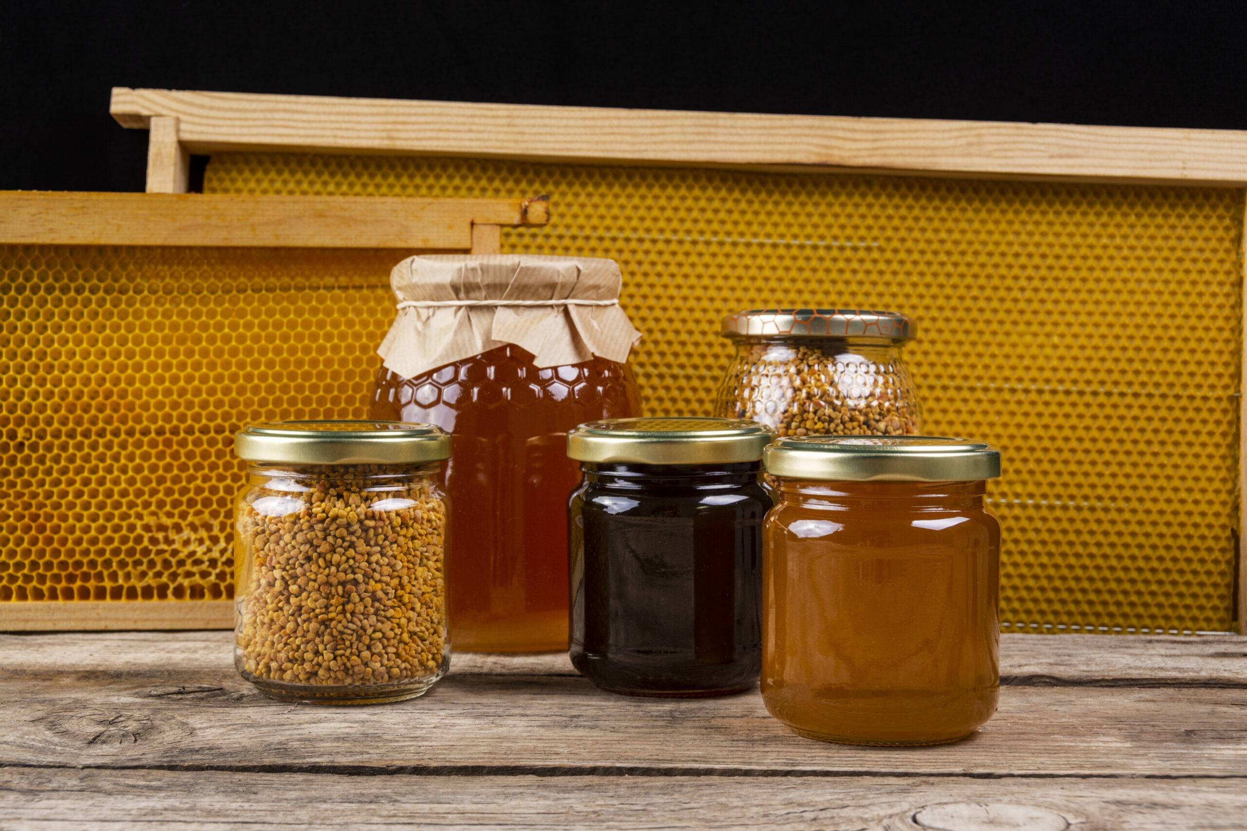 Assorted jars of honey and bee products on table
